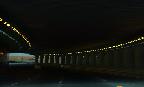 Modern Cars Driving Through Illuminated Highway Tunnel