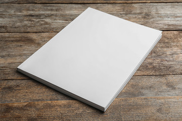 Fototapeta premium Brochure with blank cover on wooden background. Mock up for design