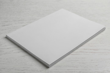 Brochure with blank cover on wooden background. Mock up for design