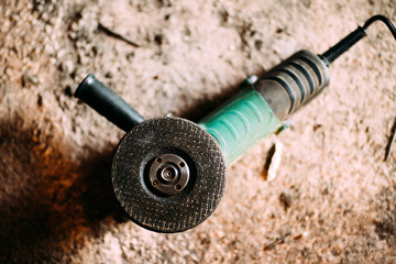 angle grinder power tool on construction site. Details of heavy duty machinery, power tools