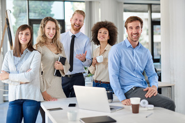 Cheerful group of business people posing in office. Multicultural group. Start up business concept.
