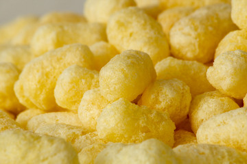 Corn sticks, food product. Molded and dried foam made from corn grits. Add to your diet. Background image.