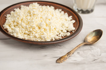 Homemade cottage cheese with raisins and candied fruits, on wooden background