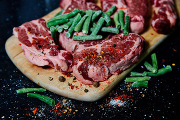 Fresh raw meat pork neck on wooden Board on black table