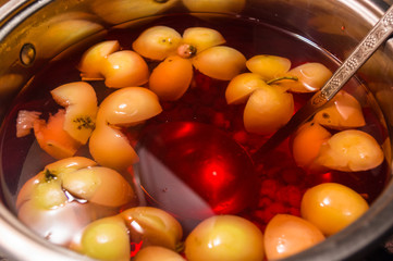 Fruit compote of apples in a saucepan with a ladle, close up