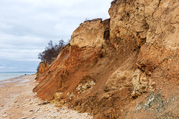 Landslide zone on Black Sea coast. Rock of sea rock shell. Zone of natural disasters during rainy season. Large masses of earth slip along slope of hill, destroy houses. Landslide - threat to life