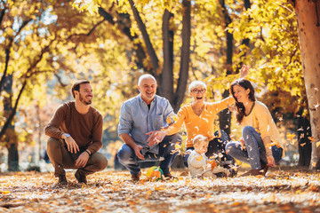 Multl generation family in autumn park having fun