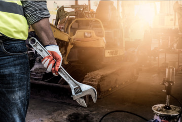 Close-up of a human hand holding the industrial tool for maintenance or machine service in the...