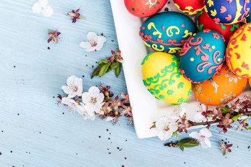 Easter eggs and spring flowers on wooden background