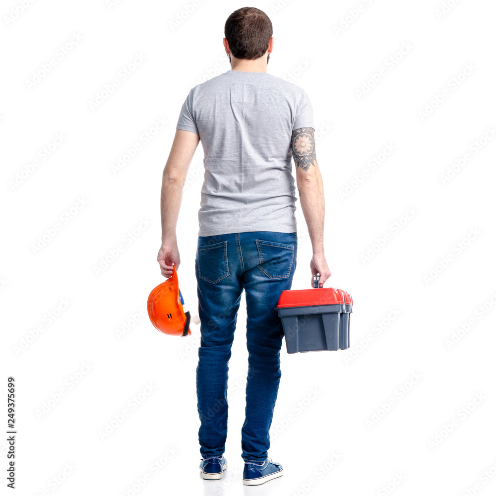 Wall mural man with building tools box and helmet in hand on white background isolation, back view