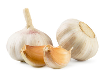 Two heads of garlic and two pieces of close-up on a white background.