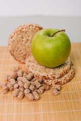 Green apple and bran. Healthy food. Diet for weight loss. Dietary bread