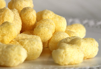 Corn sticks, food product. Molded and dried foam made from corn grits. Add to your diet. Background image.