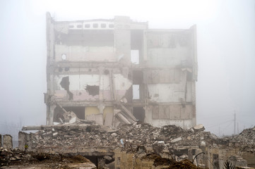 The remains of the destroyed Foundation of the building on the background of the destroyed...