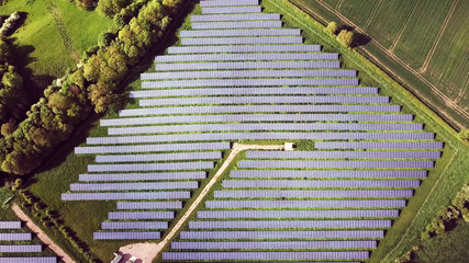 top aerial view of solar energy panels in solar energy farm, Photovoltaic power station © WADII
