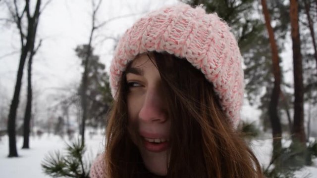 Cute portrait of brunette girl in hat. Winter park.