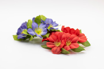 Artificial blue and red flowers isolated