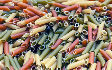 Colorful Italian pasta on the shop counter. Background made of pasta.