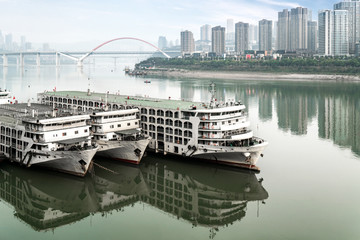 Fototapeta premium Cruise ships and skyscrapers at Chaotianmen Wharf, Chongqing, China