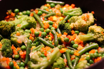 Mexican mix. Colorful vegetables are fried in a Sizzling frying pan: broccoli, corn, peas