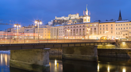 Golden lights of city above bridge in twilight time in Salzburg in Austria