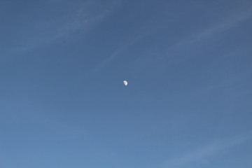 The moon in the blue sky