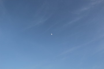 The moon in the blue sky