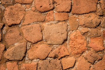 Old cobblestone road with soil between stones. Texture and background.