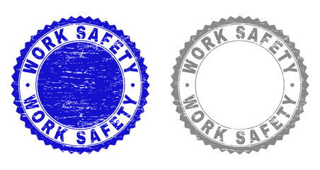 Grunge WORK SAFETY stamp seals isolated on a white background. Rosette seals with grunge texture in blue and gray colors. Vector rubber stamp imitation of WORK SAFETY label inside round rosette.