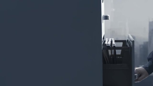 Office worker opening a filing cabinet's drawer