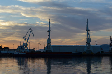 harbor cranes at sunset