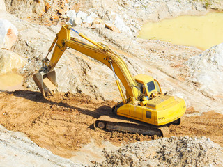 Closeup of industrial excavator working on construction site. Selective focus and crop fragment
