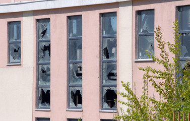 Fototapeta na wymiar Broken glass in the windows of an abandoned building