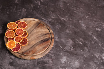 Sliced Blood oranges fruits over old dark wooden background