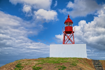 Old red lighthouse on a hill of Sao Miguel island of Azores, Portugal.