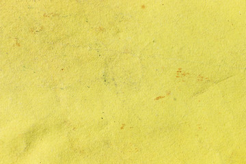 The texture of the surface of the old bright yellow cardboard. Blank vintage cardboard and paper backdrop. 