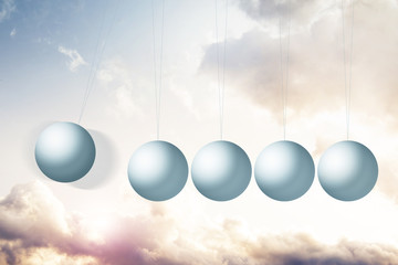 Newton's cradle on fantasy background with colorful clouds