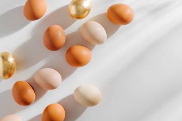 Natural Colored Eggs with morning sunlights. Stylish Compositions in pastel colors.  Easter concept.