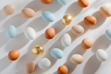 Natural Colored Eggs with morning sunlights. Stylish Compositions in pastel colors.  Easter concept.