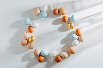 Frame made of Natural Colored Eggs with morning sunlights. Stylish Compositions in pastel colors.  Easter concept.