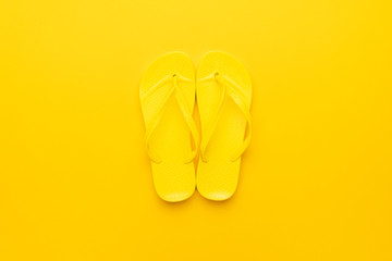 beach flip-flops on the yellow background. summer concept