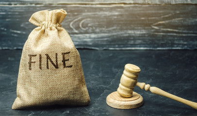 Money bag with the word Fine and the judge's hammer. Penalty as a punishment for a crime and...