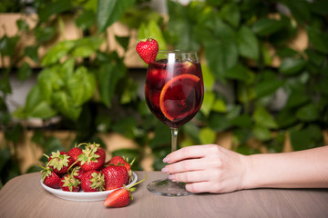 Strawberry mojito and ingredients on rustic background