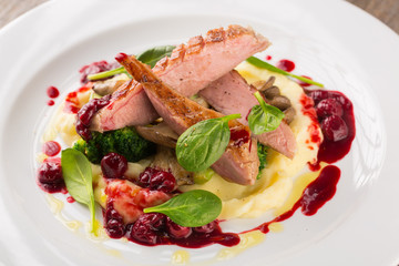 Sliced Grilled Duck breast with potatoes puree and broccoli with cherry sauce