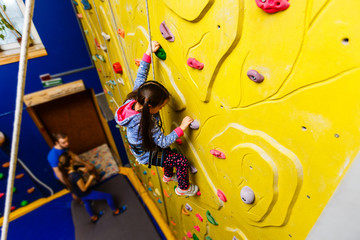 Obraz na płótnie Canvas Little Girl Climbing Rock Wall