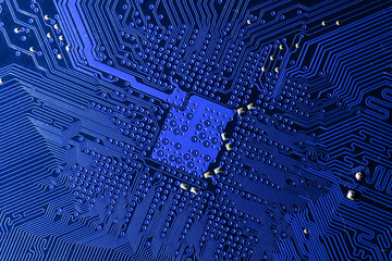 Close up photo of blue pcb printecd circuit board electric paths