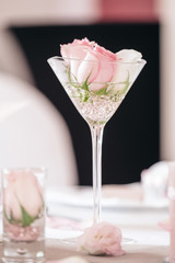 Table vase containing flowers and decoration