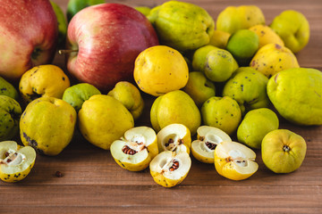 Fresh organic quince and apples from the garden on a wooden table.