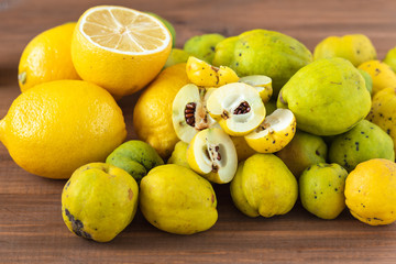 Fresh organic quince and lemon on a wooden table.