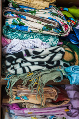 Mess in a wardrobe. Stack of old blankets